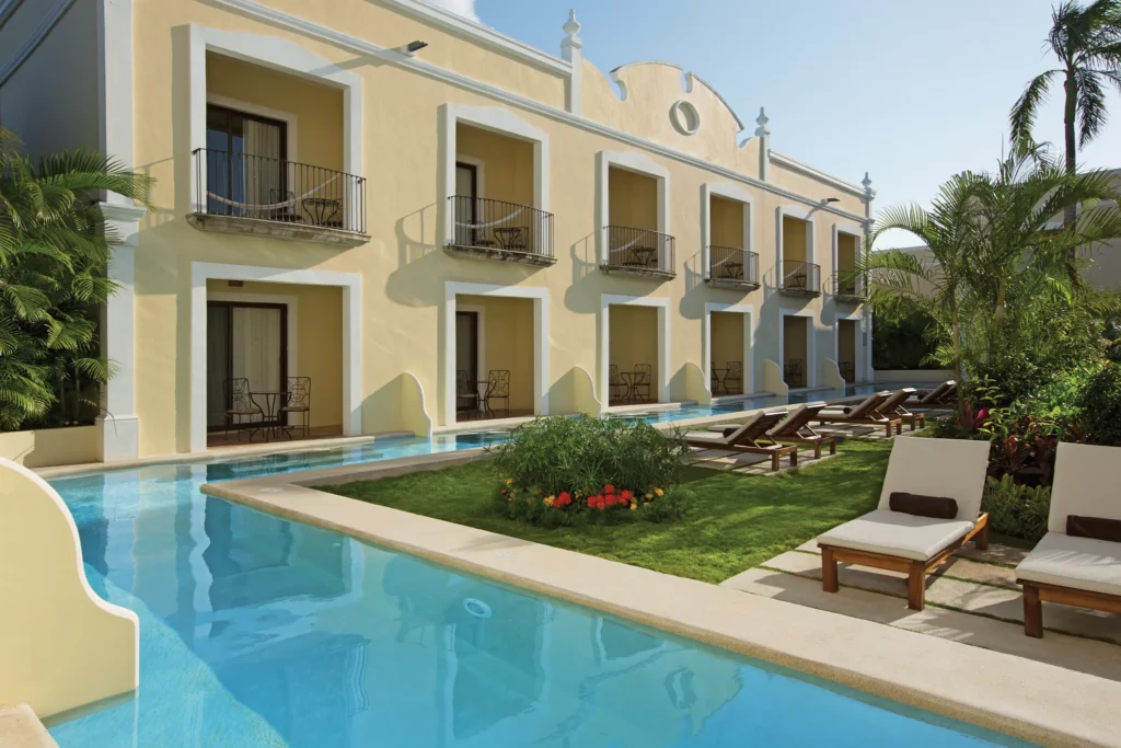 Swim-out suites with direct pool access and lounge chairs at Dreams Tulum Resort & Spa.