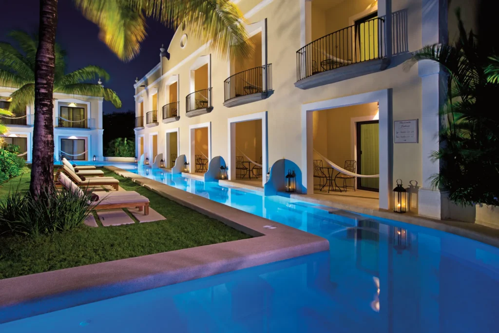 Illuminated swim-out suites with private terraces and pool access at Dreams Tulum Resort & Spa.