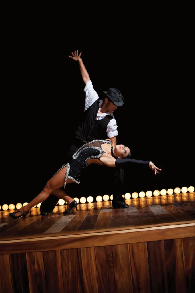 Ballroom dancers performing an elegant routine on stage during evening entertainment at Dreams Vallarta Bay Resort & Spa.
