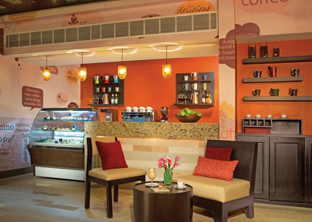 Coco Café coffee shop at Dreams Vallarta Bay Resort & Spa serving premium coffee, pastries, and deli snacks in a cozy lounge setting.