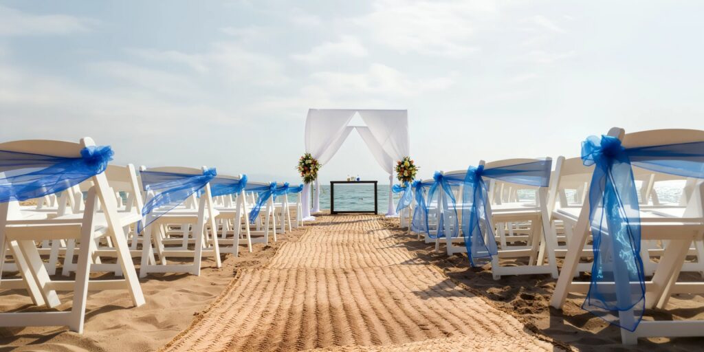 Beach wedding ceremony setup with blue décor at Dreams Vallarta Bay Resort & Spa