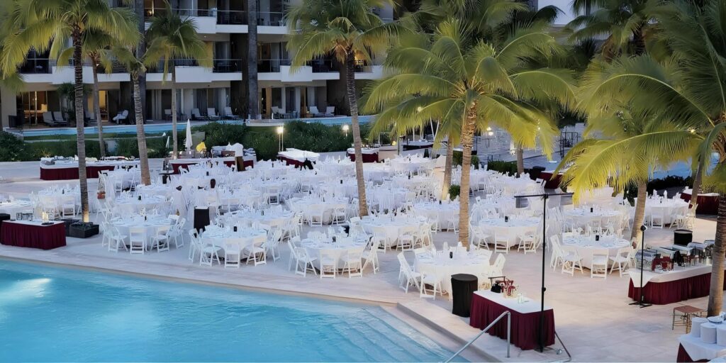Pool terrace wedding reception setup with palm trees at Dreams Vallarta Bay Resort & Spa