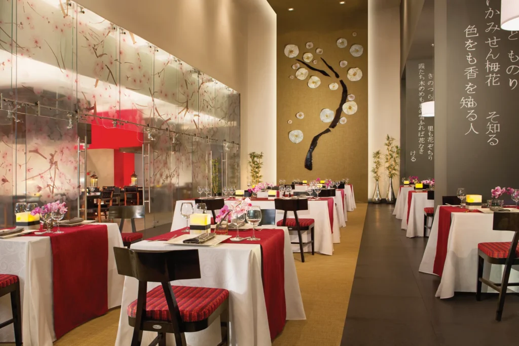 Himitsu Pan-Asian restaurant at Dreams Vallarta Bay Resort & Spa featuring elegant dining tables, Asian-inspired décor, and contemporary ambiance.