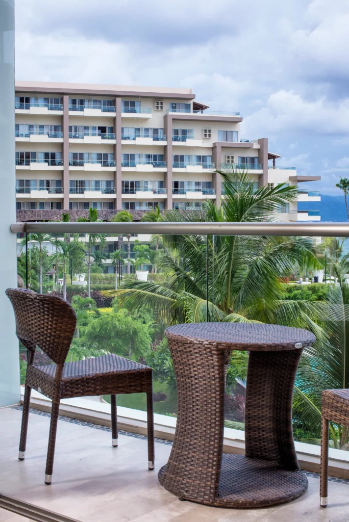Private furnished balcony with garden views at the Junior Suite Garden View Double at Dreams Vallarta Bay Resort & Spa.