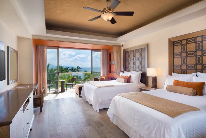 Junior Suite Garden View with two double beds and private balcony at Dreams Vallarta Bay Resort & Spa.