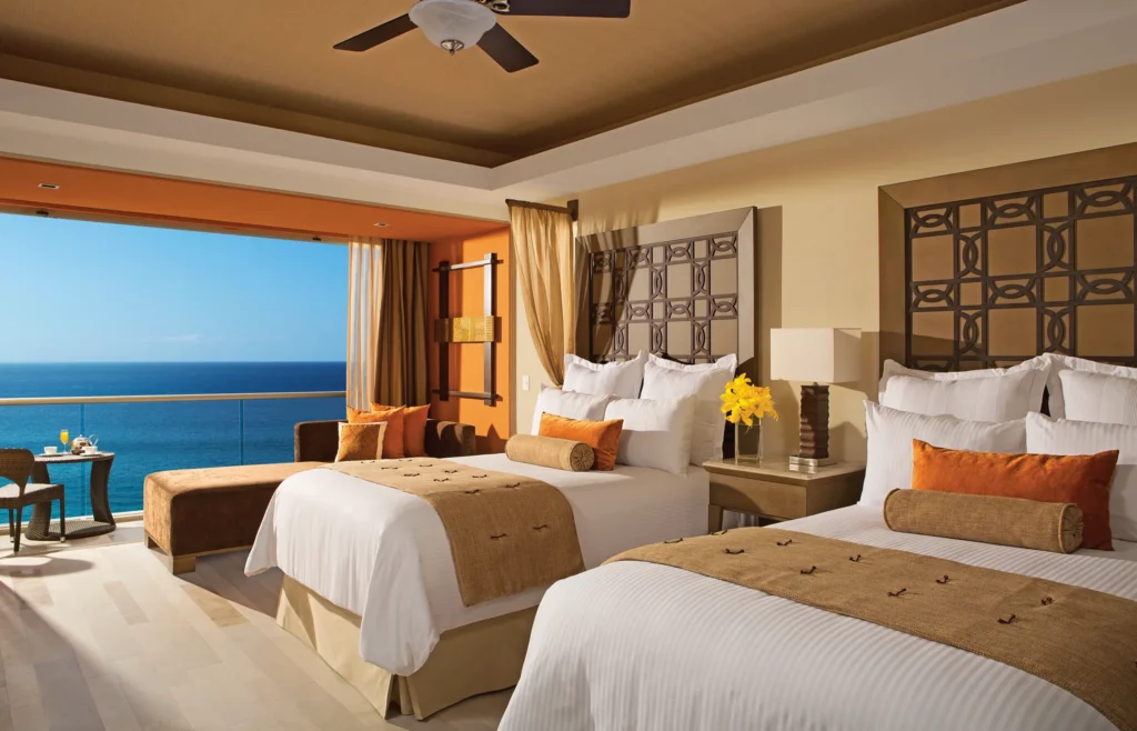 Junior Suite Ocean View with two double beds and balcony at Dreams Vallarta Bay Resort & Spa.