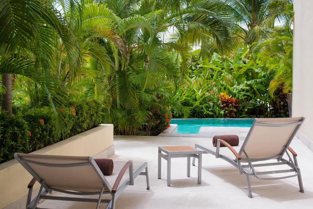 Private terrace with loungers and swim-out pool access at the Junior Suite Swim Out at Dreams Vallarta Bay Resort & Spa.
