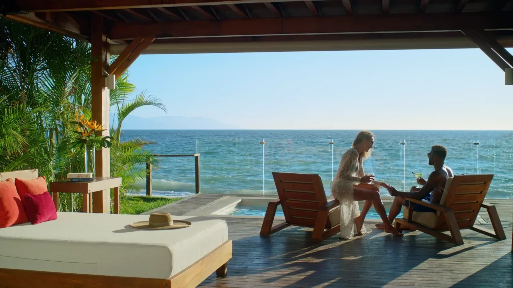 Couple relaxing on a private oceanfront terrace at Dreams Vallarta Bay Resort & Spa with Pacific Ocean views.