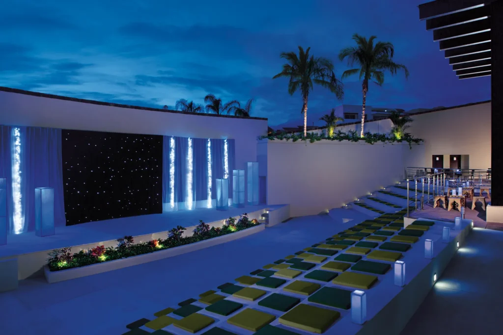 Outdoor entertainment theater stage at Dreams Vallarta Bay Resort & Spa illuminated for evening shows.