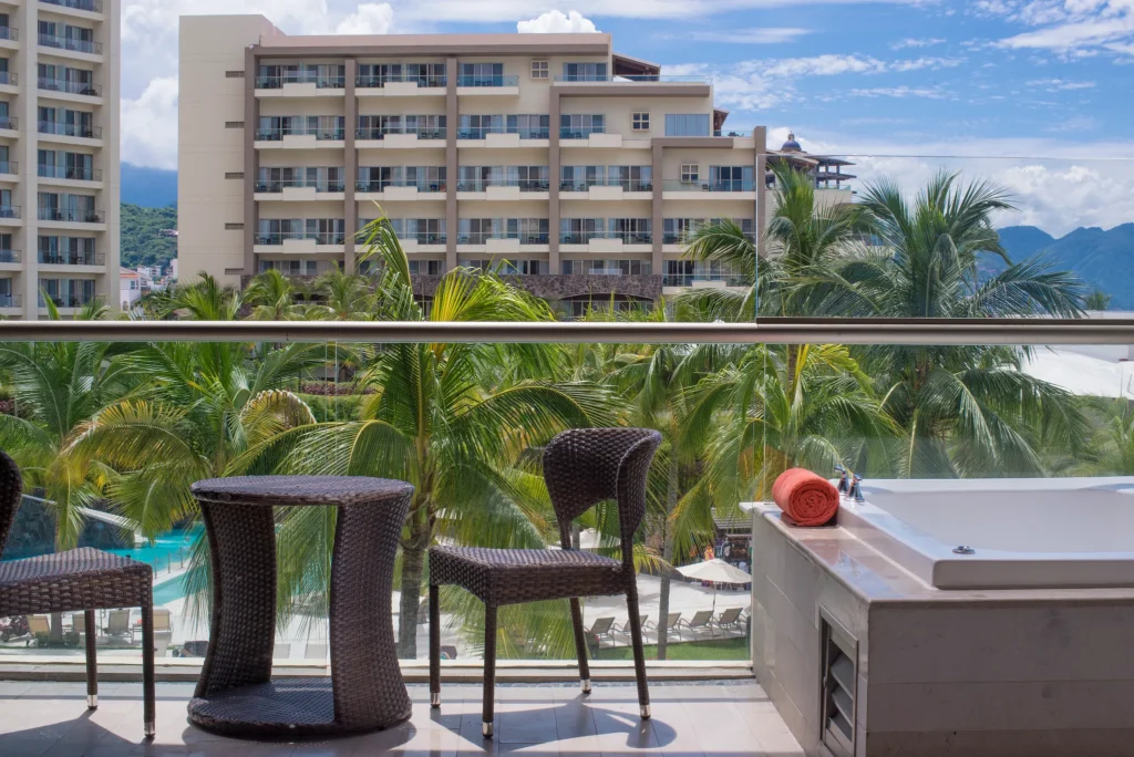 Private balcony with outdoor hot tub in the Preferred Club Junior Suite Garden View at Dreams Vallarta Bay Resort & Spa.