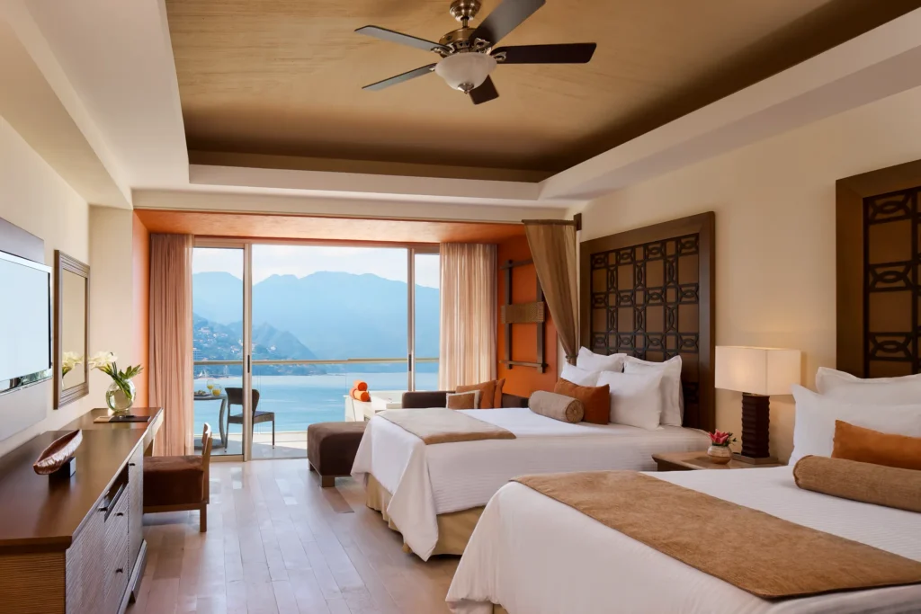 Preferred Club Junior Suite Ocean View with two double beds at Dreams Vallarta Bay Resort & Spa.