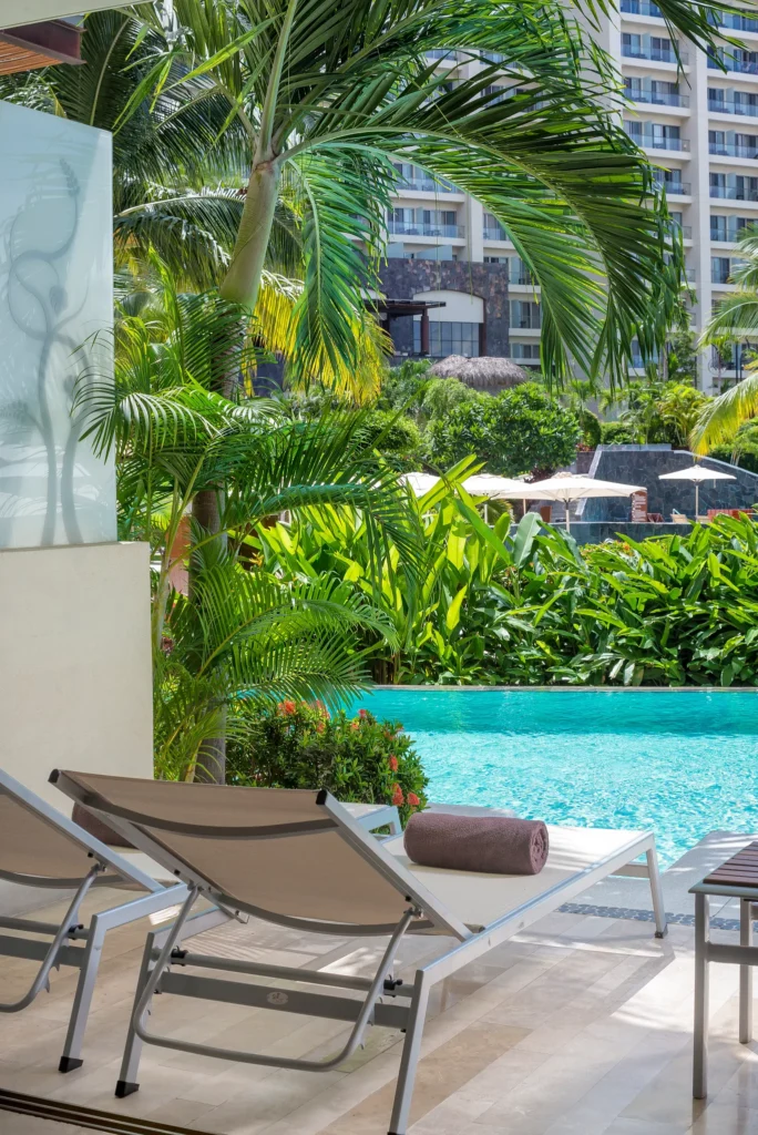 Preferred Club Junior Suite Swim Out terrace with lounge chairs and direct pool access at Dreams Vallarta Bay Resort & Spa.