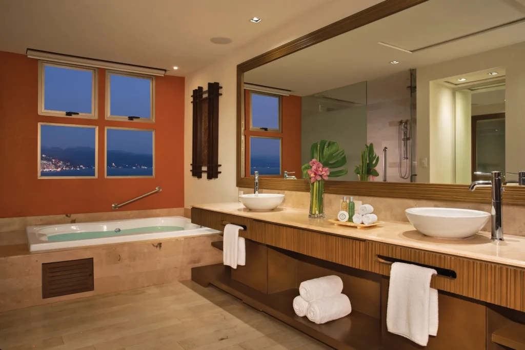 Preferred Club Master Suite Partial Ocean View bathroom with double vanity and soaking tub at Dreams Vallarta Bay Resort & Spa.