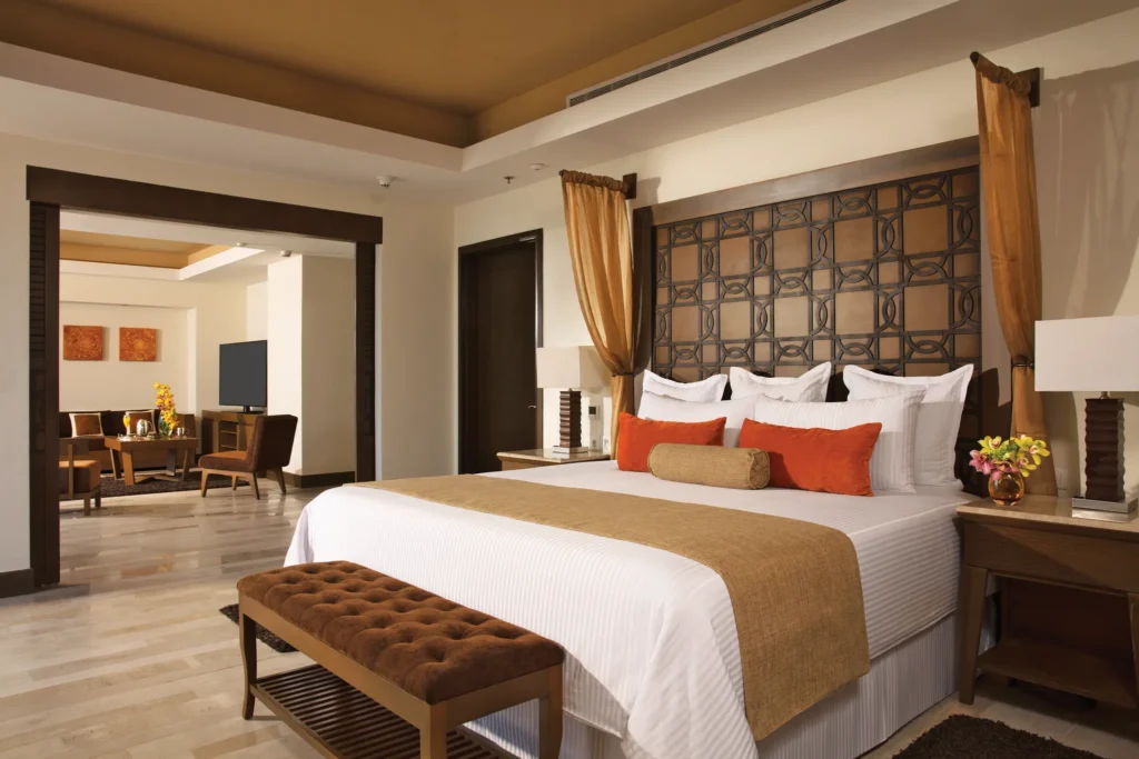 Preferred Club Master Suite Partial Ocean View bedroom with king bed at Dreams Vallarta Bay Resort & Spa.