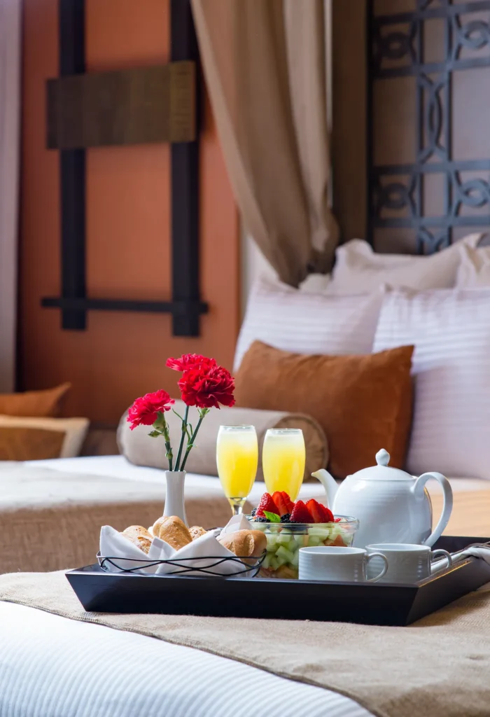 Room service breakfast with fruit, pastries, and mimosas in the Preferred Club Master Suite Swim Out at Dreams Vallarta Bay.