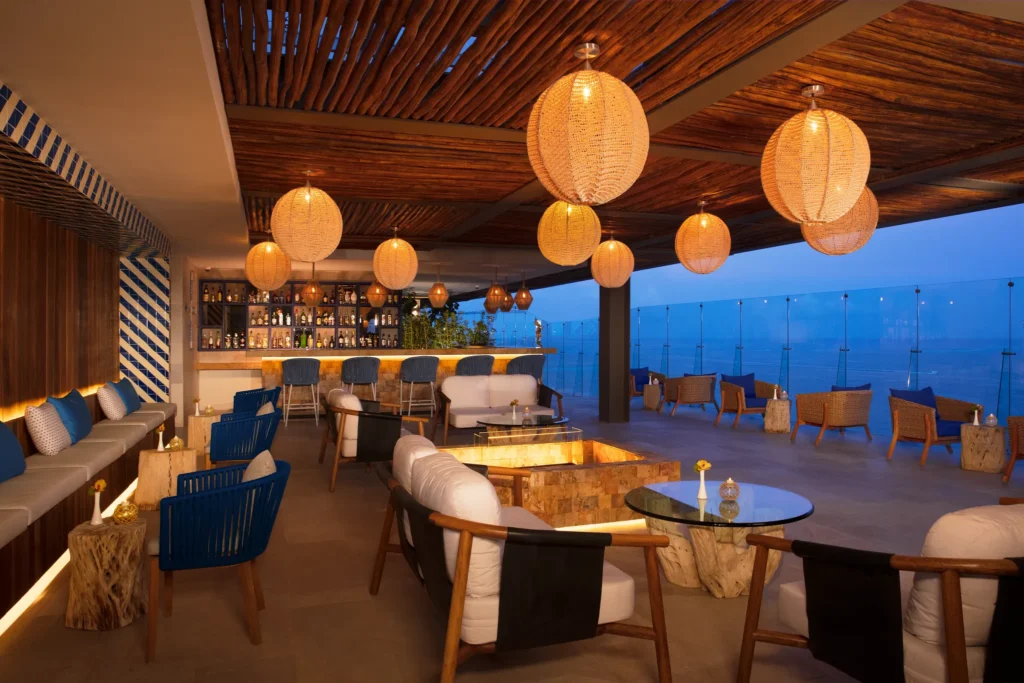 Bar 360 rooftop bar at Dreams Vista Cancun featuring panoramic ocean and city views from the 16th floor with stylish open-air seating.