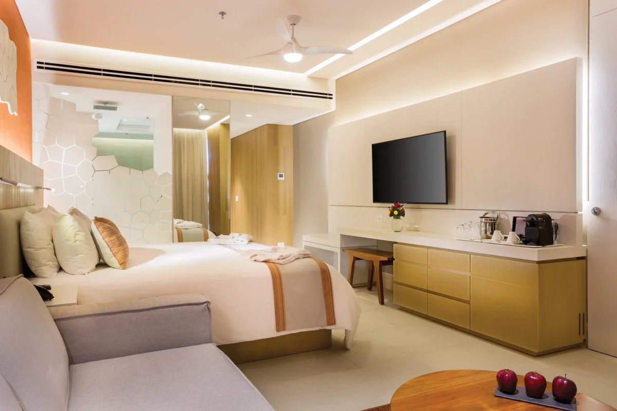 Deluxe Golf & Ocean View room with king bed, modern décor, and seating area at Dreams Vista Cancun Golf & Spa Resort.