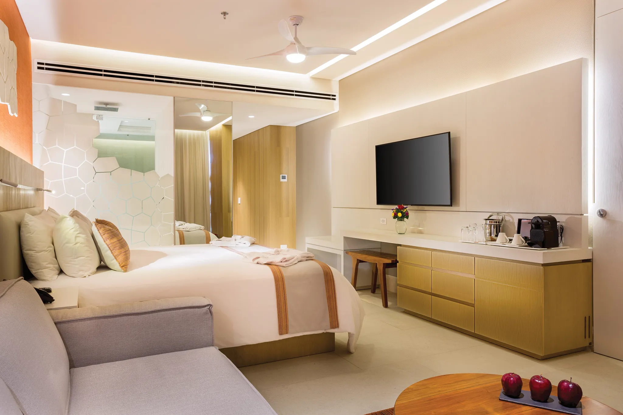 Deluxe Golf & Ocean View room with king bed, modern décor, and seating area at Dreams Vista Cancun Golf & Spa Resort.
