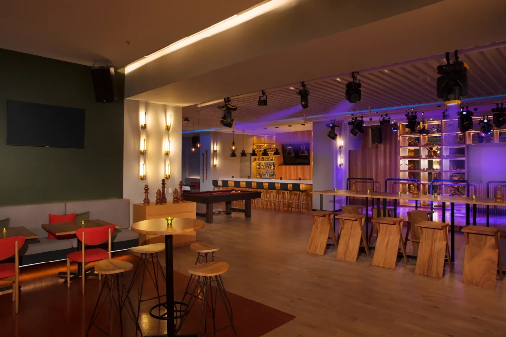 Desires sports bar and disco at Dreams Vista Cancun featuring modern lounge seating, multiple TV screens, and a vibrant adults-only dance floor.