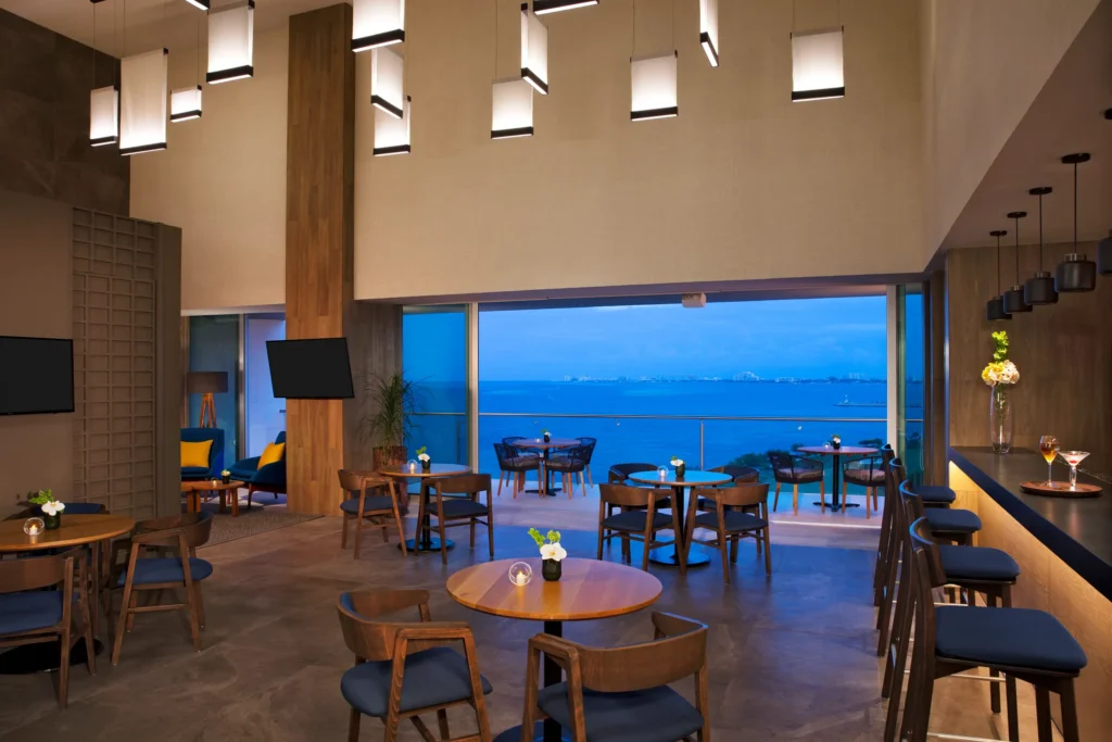 Preferred Club Bar at Dreams Vista Cancun featuring an exclusive lounge setting with premium drinks, continental breakfast, and upscale seating.