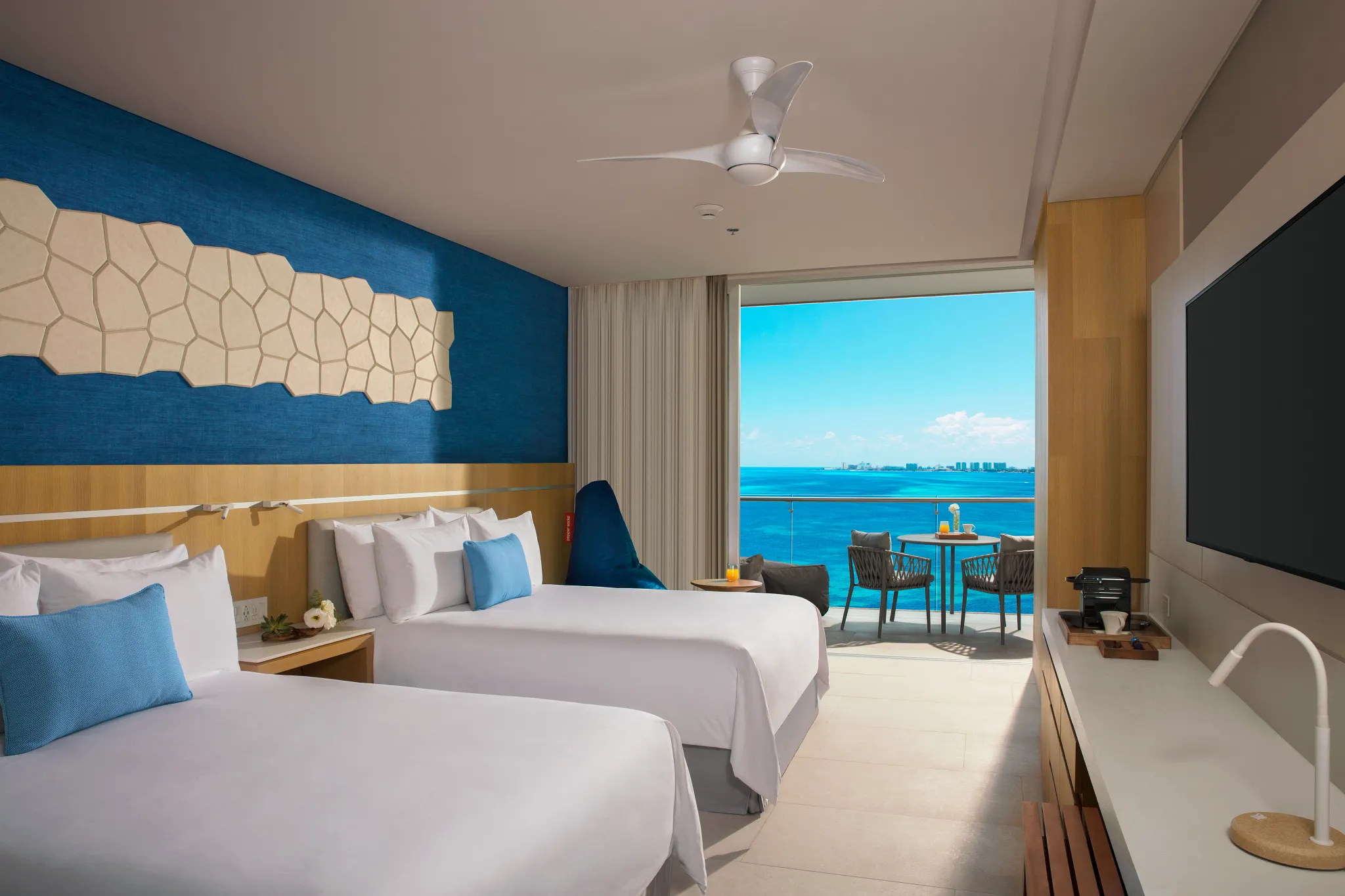 Preferred Club Deluxe Family Suite Ocean View with two queen beds and private balcony overlooking the Caribbean at Dreams Vista Cancun.