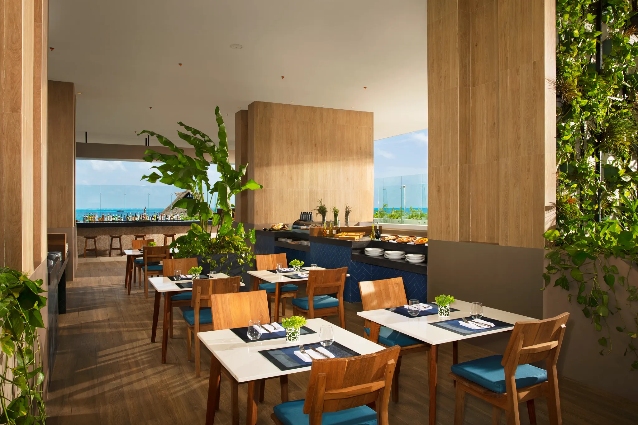 Sugar Reef lounge bar at Dreams Vista Cancun featuring stylish open-air seating, handcrafted cocktails, and scenic views of Isla Mujeres.