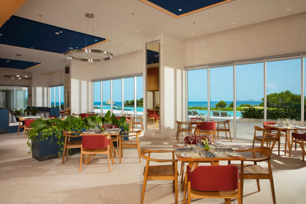 World Café buffet restaurant at Dreams Vista Cancun featuring modern dining space, international cuisine stations, and a vibrant casual atmosphere.