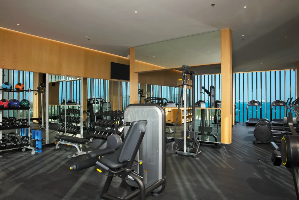 Modern fitness center with ocean views and equipment at Dreams Vista Cancun Golf & Spa Resort.