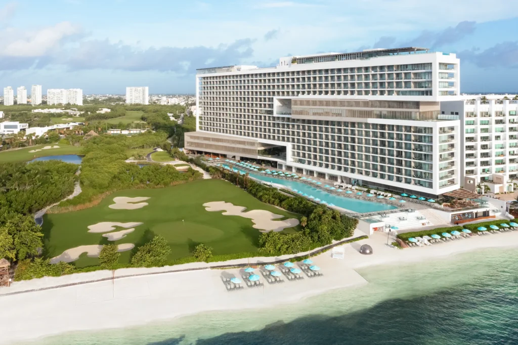 Elevated rooftop pool overlooking golf course and city views at Dreams Vista Cancun Golf & Spa Resort.