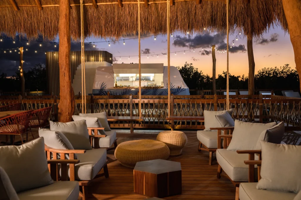Amber Sunset Bar at Hyatt Vivid Grand Island featuring ocean-view seating, golden sunset skies, and handcrafted specialty cocktails.