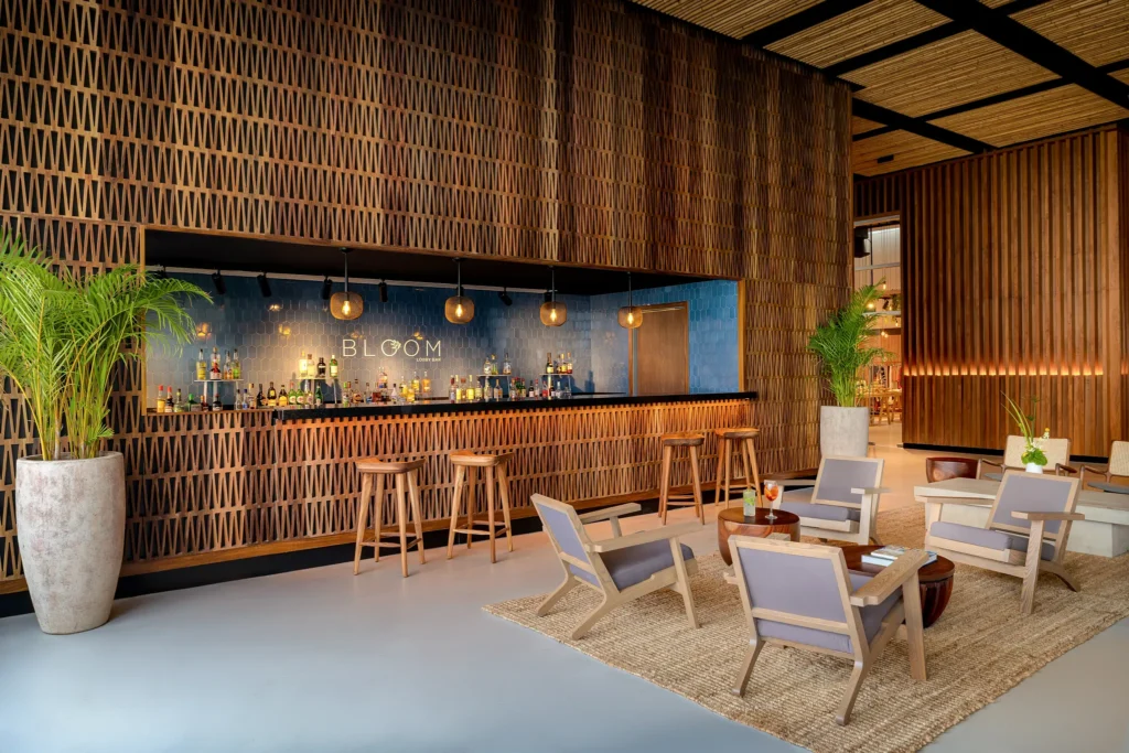 Bloom lobby bar at Hyatt Vivid Grand Island featuring a stylish lounge setting with cocktails and live evening music.