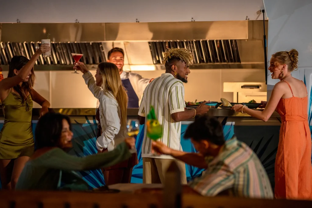 Friends enjoying drinks and light bites in a modern restaurant setting at Hyatt Vivid Grand Island.