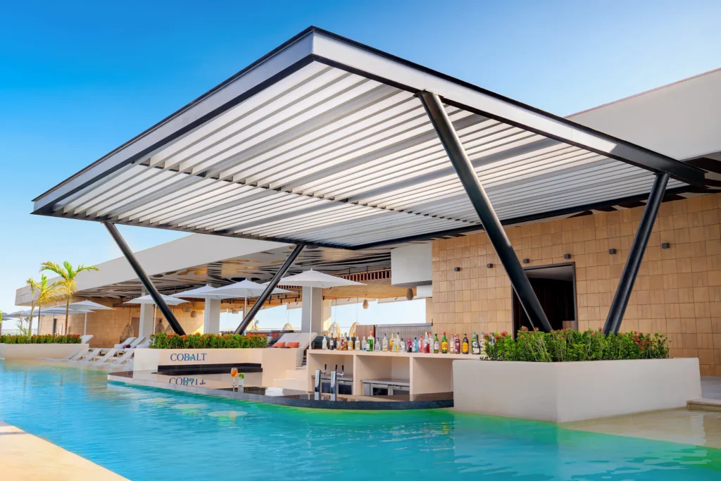 Cobalt rooftop swim-up bar at Hyatt Vivid Grand Island featuring an exclusive poolside setting with cocktails and panoramic resort views.