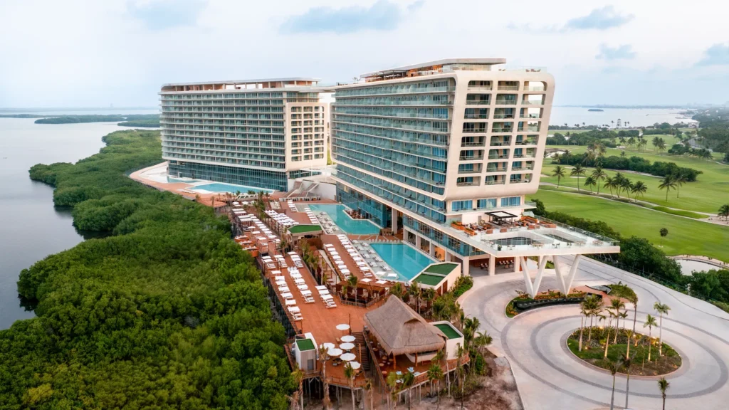 Exterior view of Hyatt Vivid Grand Island with modern architecture, pools, and surrounding nature.