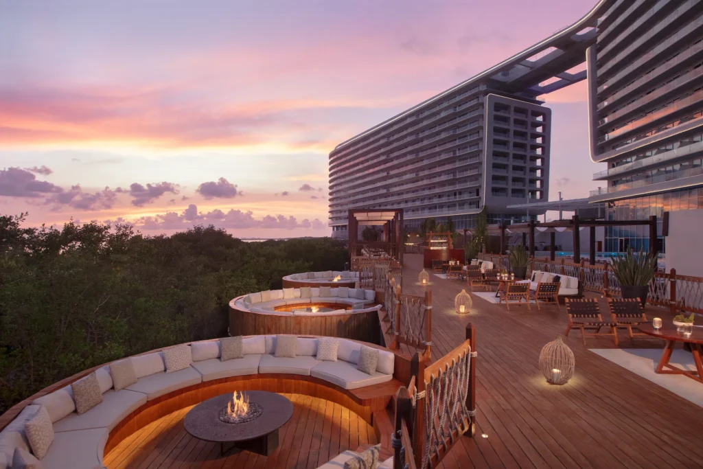 Fire Pit Deck lounge seating with circular fire pits at sunset at Hyatt Vivid Grand Island