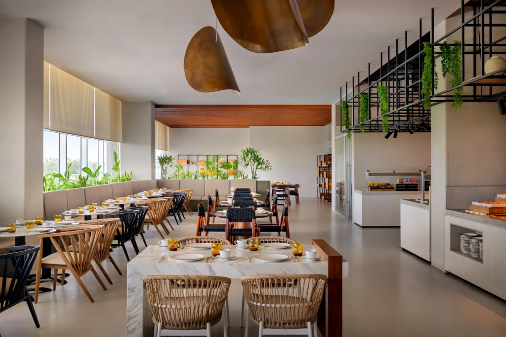 Galeria International Café at Hyatt Vivid Grand Island featuring a buffet with diverse local and international dishes across multiple live cooking stations.