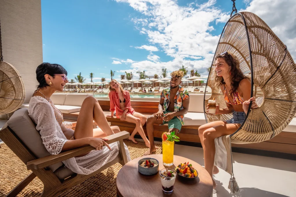 Guests socializing in a stylish indoor bar and lounge at Galeria at Hyatt Vivid Grand Island.
