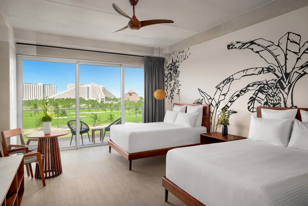 Junior Deluxe Suite Golf View with two double beds and private balcony overlooking the golf course at Hyatt Vivid Grand Island.