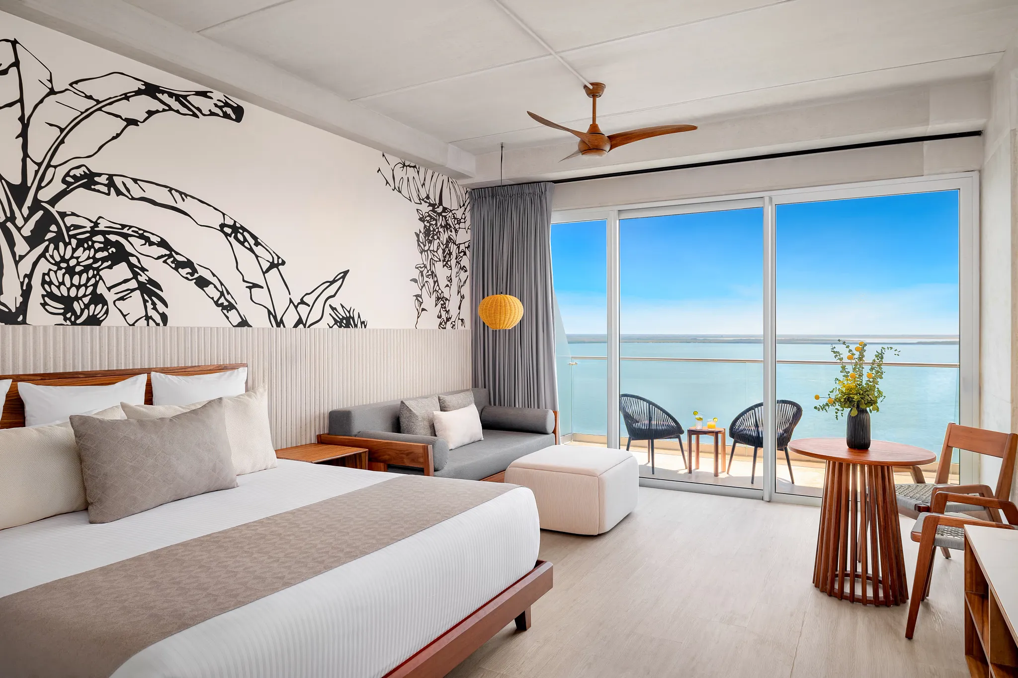 Junior Suite Bay View with king bed, private balcony, and ocean-facing seating area at Hyatt Vivid Grand Island.