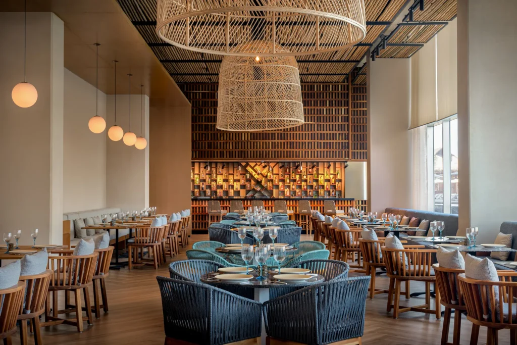Mediterraneo restaurant at Hyatt Vivid Grand Island featuring Mediterranean seafood dishes in an elegant poolside dining setting.