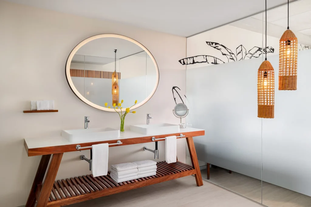 Premium Suite Golf View bathroom with double vanities, illuminated round mirror, and walk-in shower at Hyatt Vivid Grand Island.