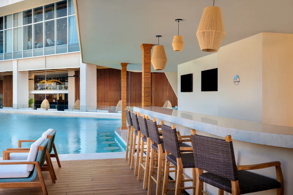 Seafoam swim-up bar at Hyatt Vivid Grand Island located in the main pool, serving refreshing cocktails in a lively poolside setting.