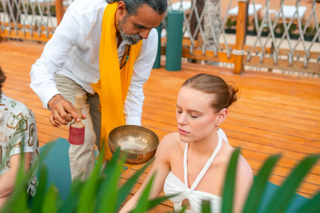 Sound healing session with singing bowls during a wellness experience at Hyatt Vivid Grand Island.