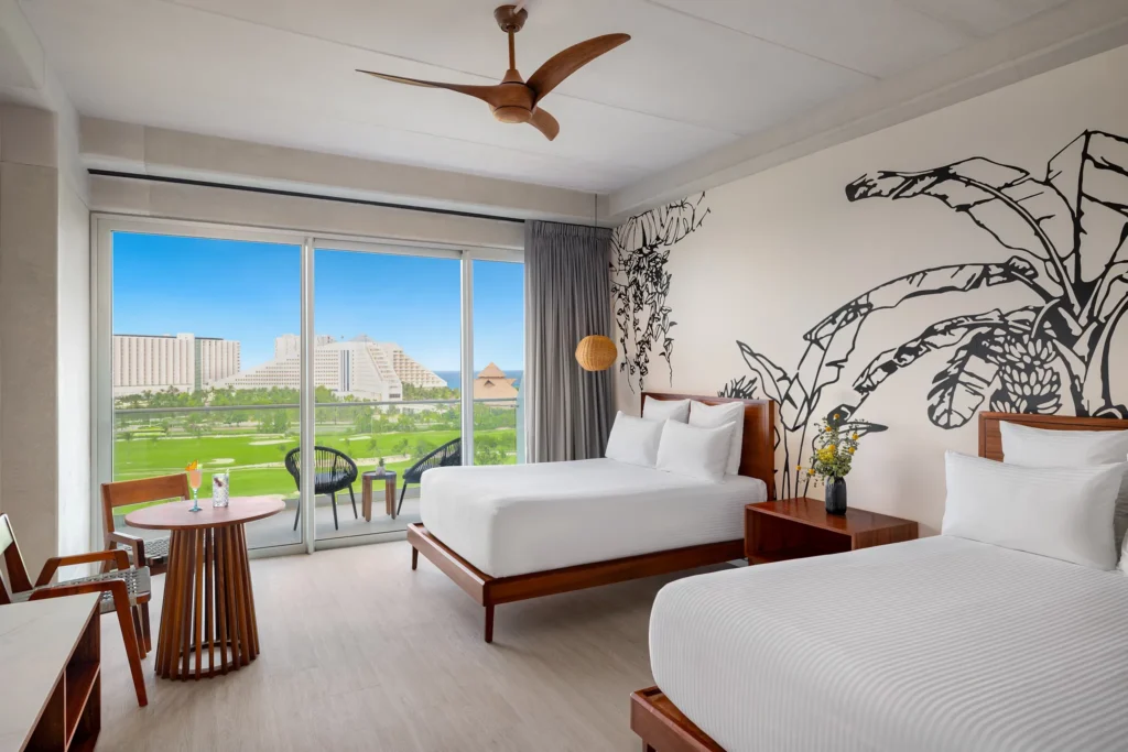 Vantage Club Junior Suite Golf and Ocean View with two double beds and private balcony at Hyatt Vivid Grand Island.