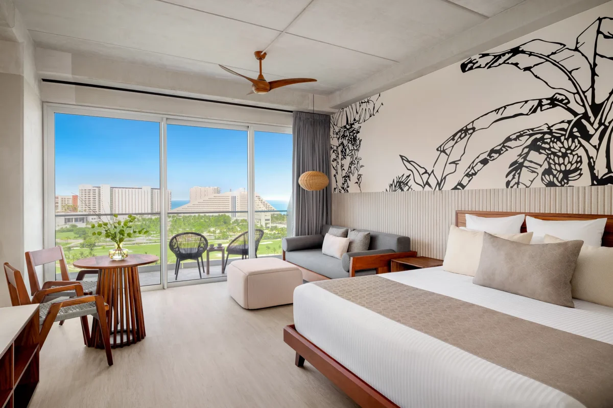 Vantage Club Junior Suite Golf and Ocean View with king bed and balcony overlooking golf course and ocean at Hyatt Vivid Grand Island.