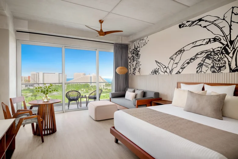 Vantage Club Junior Suite Golf and Ocean View with king bed and balcony overlooking golf course and ocean at Hyatt Vivid Grand Island.