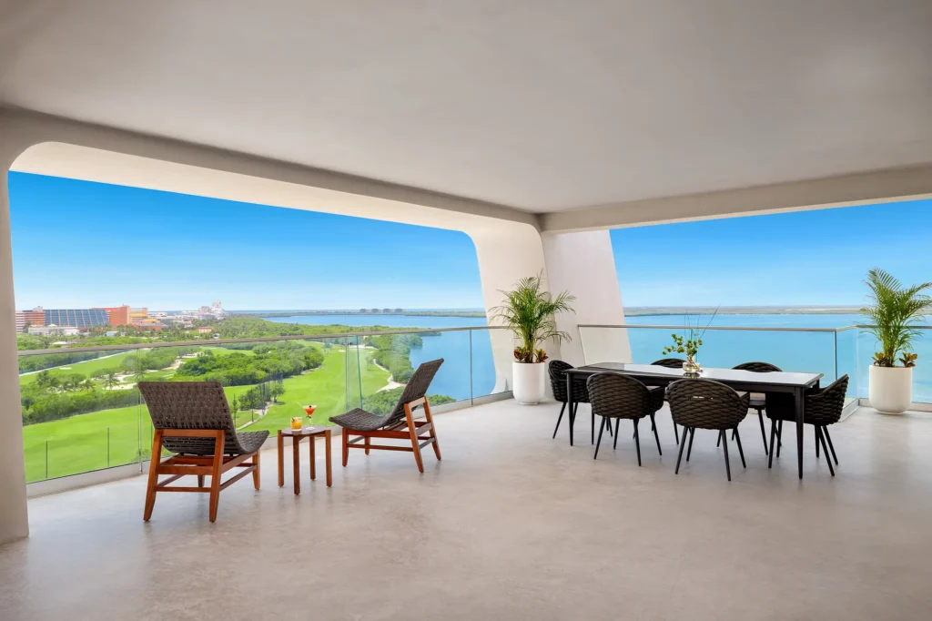 Private balcony terrace with lounge seating and bay views at Hyatt Vivid Grand Island Vantage Club Master Suite.