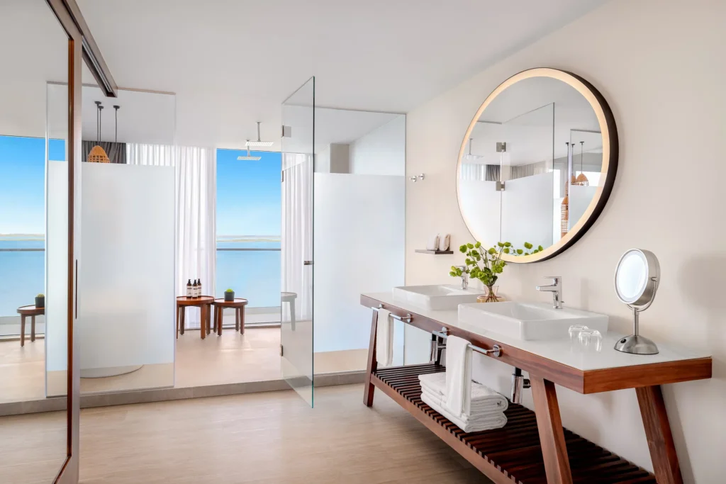 Vantage Club Master Suite Bay View bathroom with soaking tub, double vanities, and glass shower at Hyatt Vivid Grand Island.