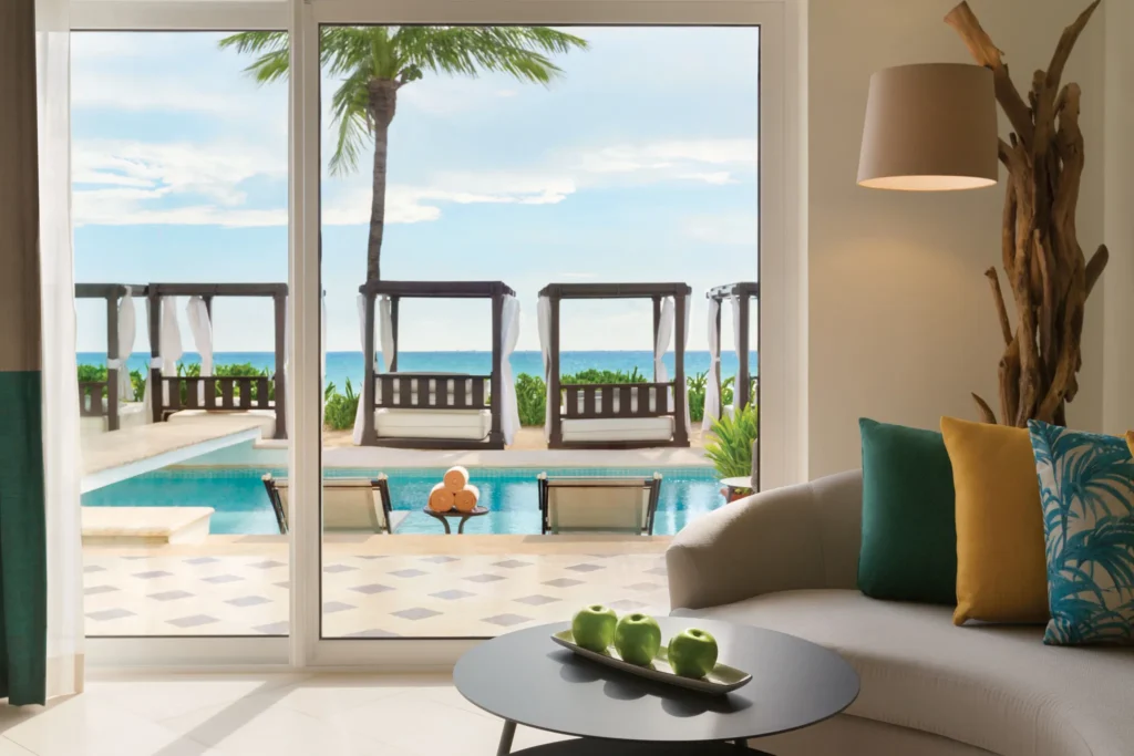 Oceanfront view from Junior Suite Oceanfront King overlooking pool cabanas and the Caribbean Sea at Hyatt Vivid Playa del Carmen.