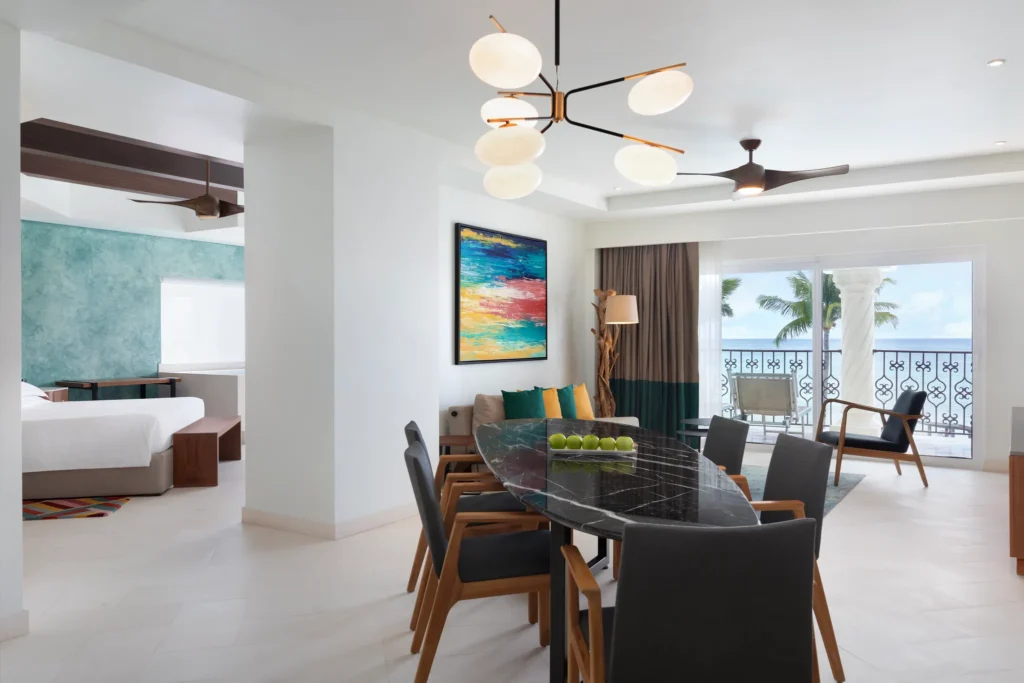 One Bedroom Suite Oceanfront King with dining area and ocean view balcony at Hyatt Vivid Playa del Carmen.